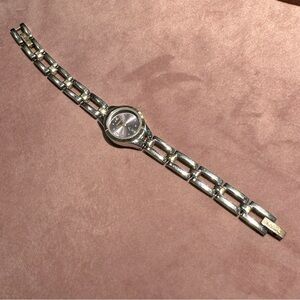 Fossil watch with a blueish purplish face, band silver and gold toned